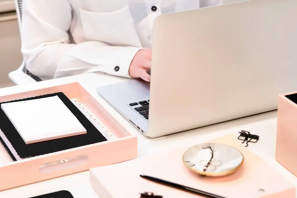 woman at computer with full desk